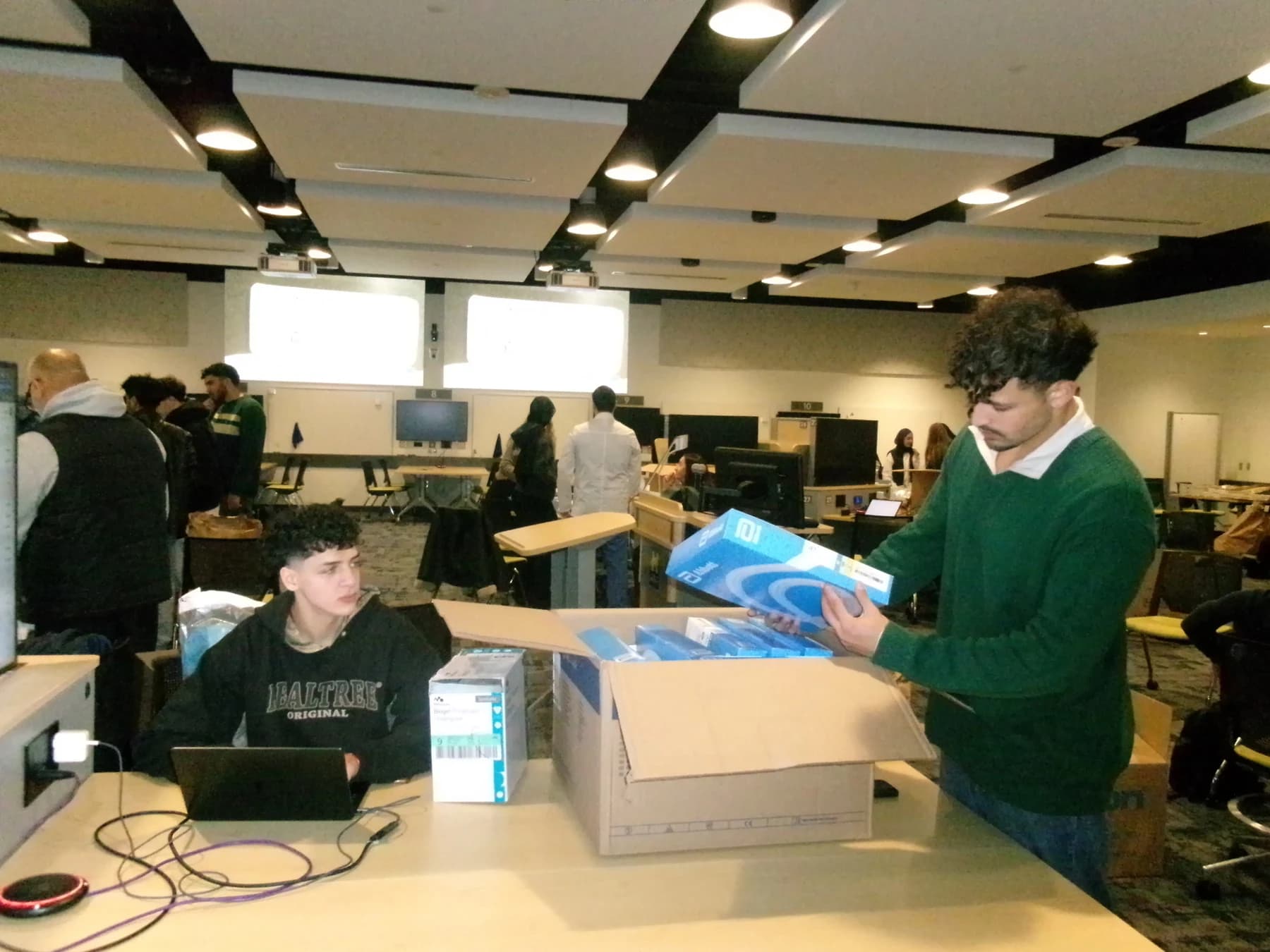 Project Resurge volunteers checking boxed medical supplies at a sorting event